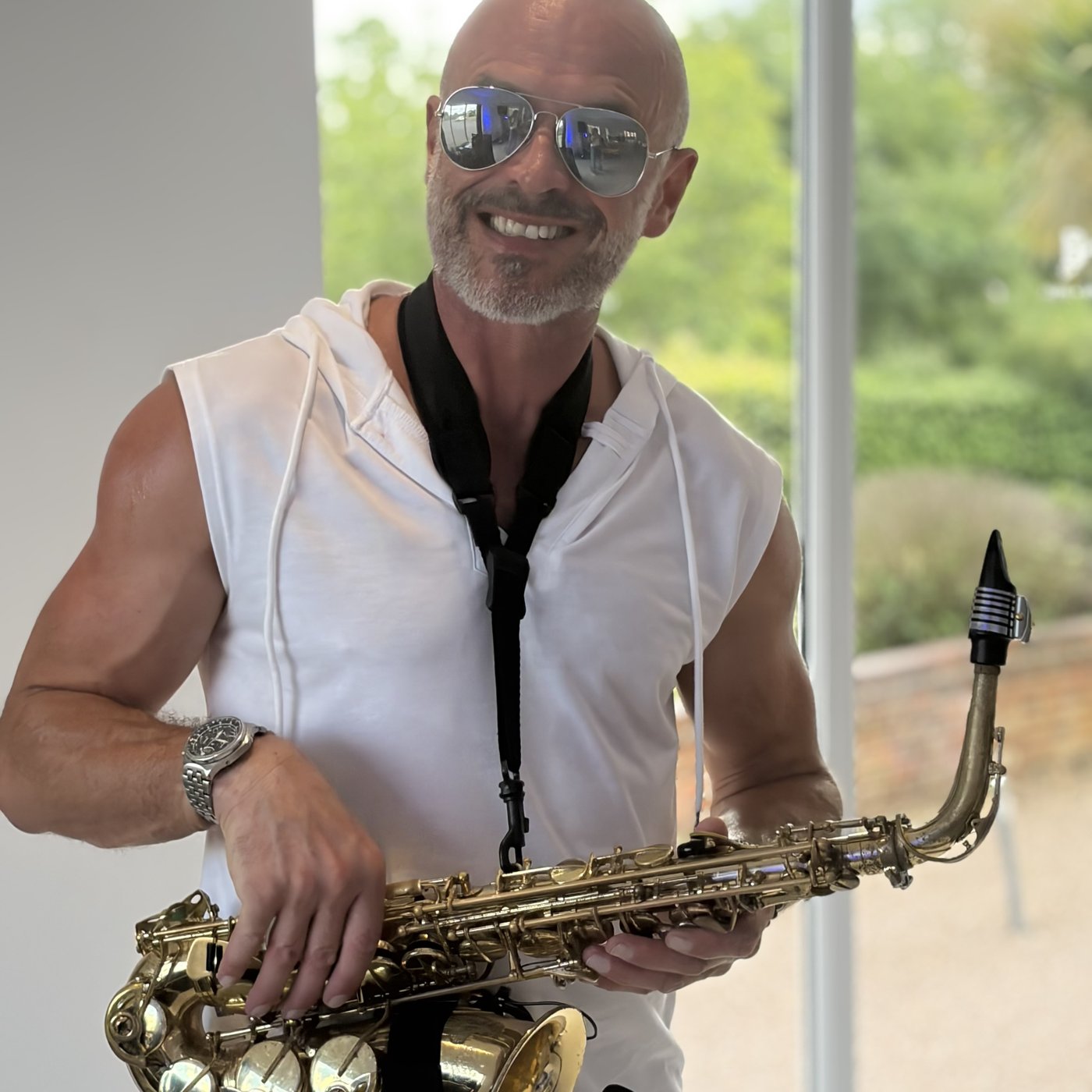 Paul Martyn smiling, holding his saxophone