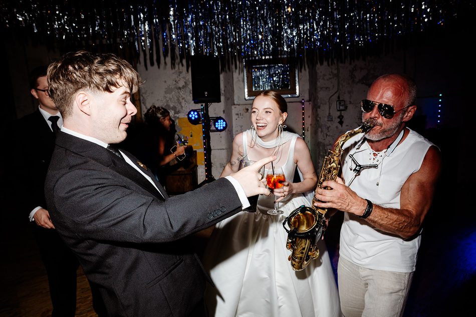 Paul Martyn playing saxophone to the bride and groom on the dance floor