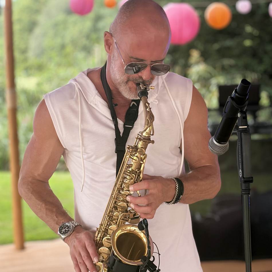 Paul Martyn playing saxophone at a garden party